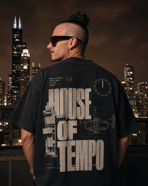 Founder wearing The Blueprint Tee back view on a Chicago rooftop